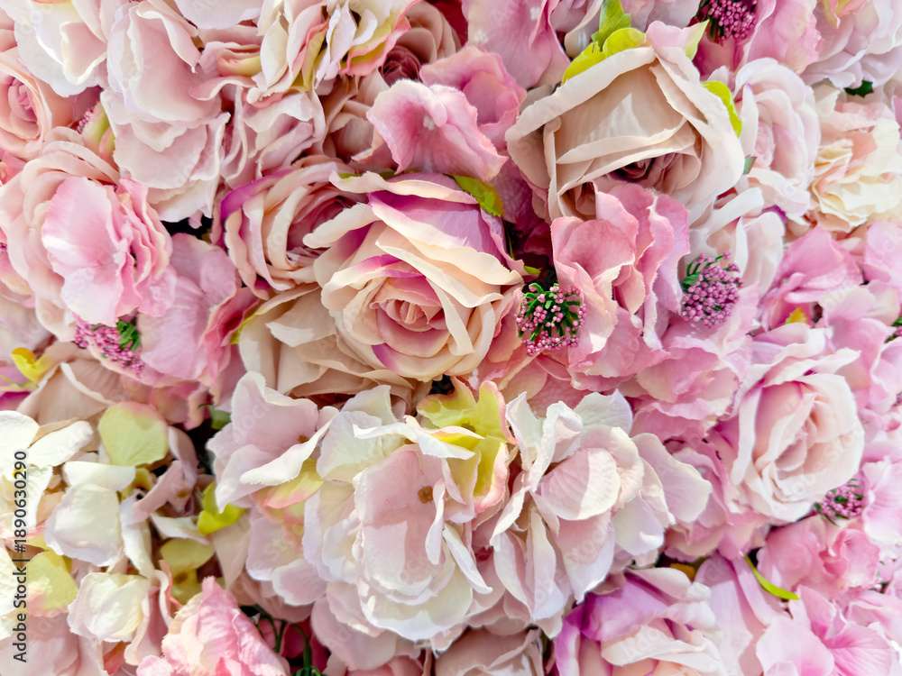 Fototapeta premium Floral wall decoration of pink and white artificial roses flowers