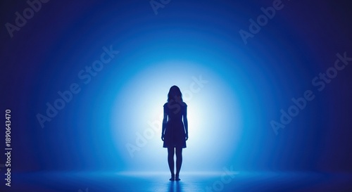Silhouette of a Woman Standing in Front of a Soft Blue Light,Evoking Themes of Mystery,Reflection,Dreamlike Atmosphere,concept of the Center for Reproductive Medicine,IVF.Copy Space.