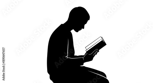Silhouette of a person deeply engrossed in reading a book.