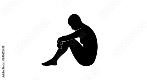 Silhouette of a person sitting alone in contemplation.