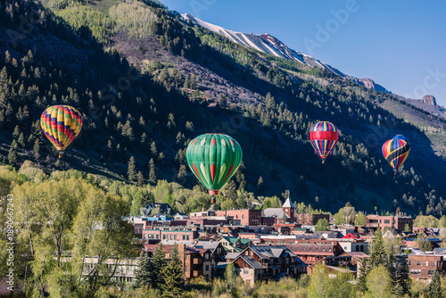 Hot Air Balloons Floating Over Mountain Valley at Sunrise