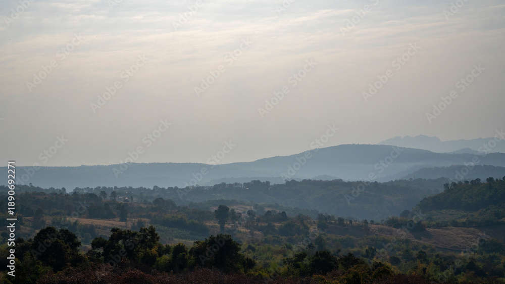 Obraz premium Valley is surrounded by mountains adding to the sense of serenity.