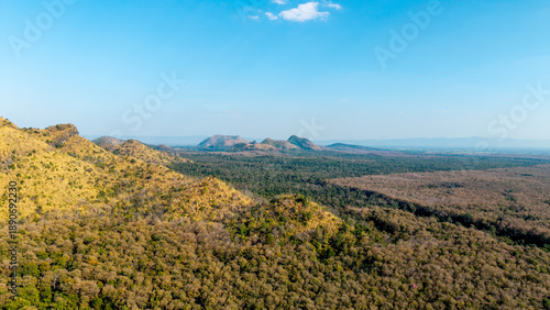 Wallpaper Mural Wide aerial vast expanse of forested hills and distant mountain ranges under clear blue sky. Torontodigital.ca