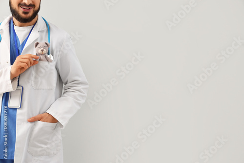 Male pediatrician with toy ...