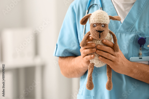 Male pediatrician with toy ...