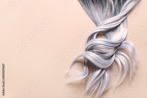 Curly grey hair on brown ba...