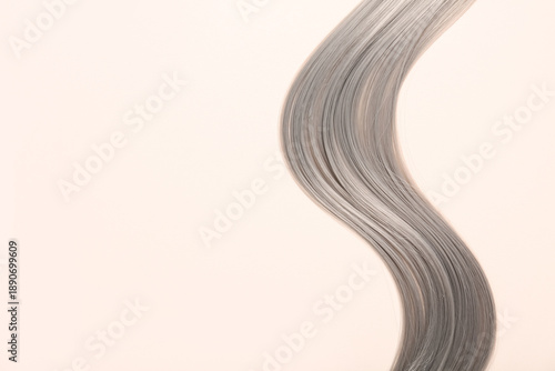 Grey hair strand on beige b...