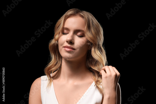 Blonde young woman with cur...