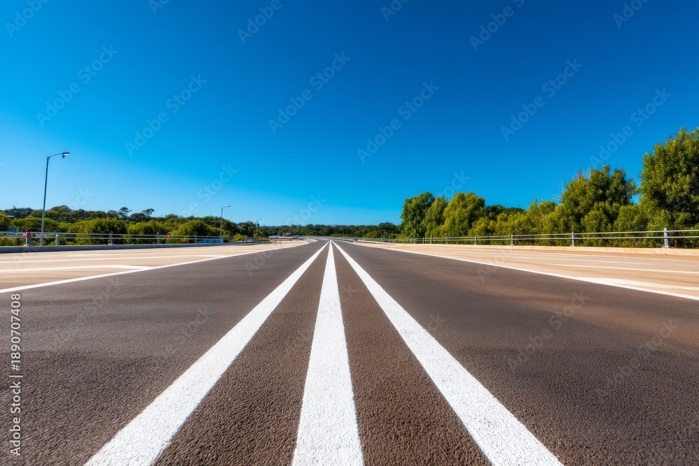 Fototapeta premium Expansive Highway Stretching Into Distance Without Vehicles or Obstacles