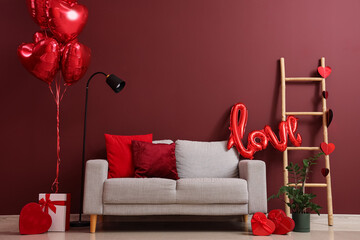 Interior of festive living room with grey sofa, gifts and heart-shaped balloons. Valentine's Day celebration