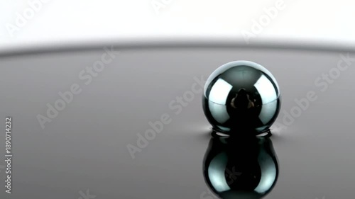 Steel Ball Bearing on Reflective Surface.