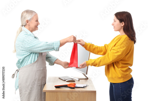 Mature female cashier with ...