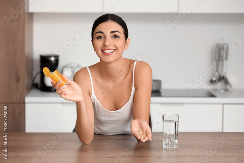 Young woman with vitamin E ...
