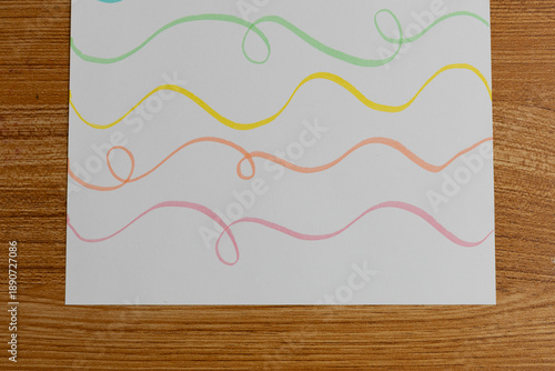 Colorful Pastel Wavy Lines on White Paper Flat Lay