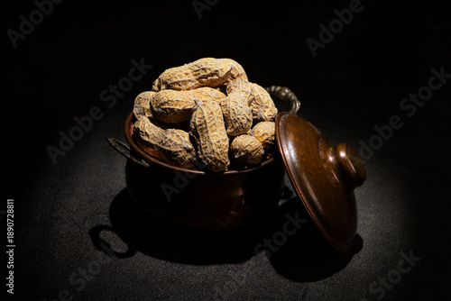 Roasted Peanut in Shell with Salt in a vintage metallic pot