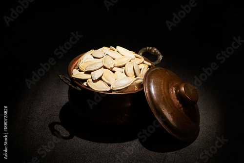 Roasted White Fat Pumpkin Seeds without Salt in a vintage metallic pot
