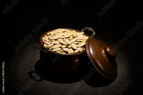 Roasted White Thin Pumpkin Seeds without Salt in a vintage metallic pot