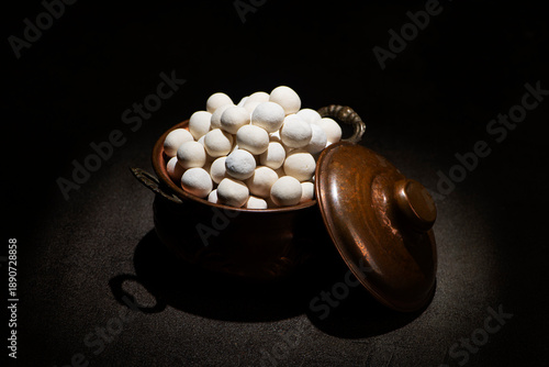 Roasted crispy white chickpeas in a vintage metallic pot