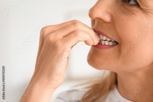 Worried mature woman biting...