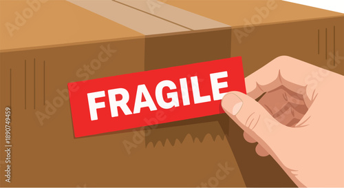 Fragile label being affixed to a cardboard box by a hand, indicating care needed during transit