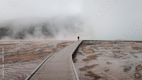 Photos Tourist exploring the Midway Geyser Basin in Yellowstone National Park