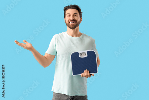 Young man with weight scale...