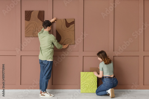 Couple arranging abstract w...