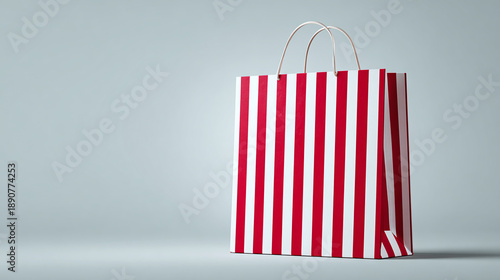 A shopping bag with a vibrant red and white striped pattern, evoking a sense of joy and retail therapy