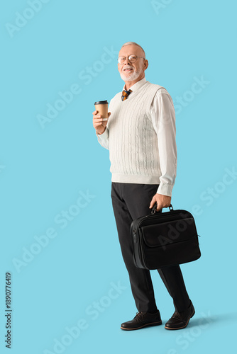 Senior businessman with cup...
