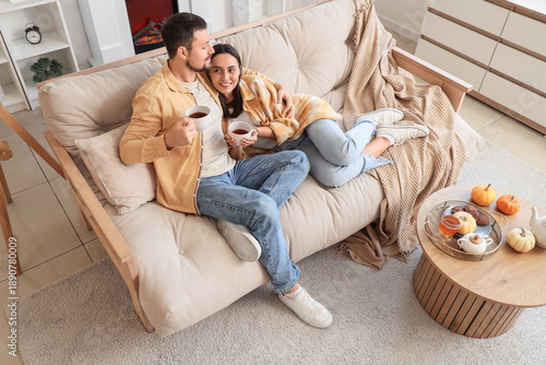 Happy young couple drinking...