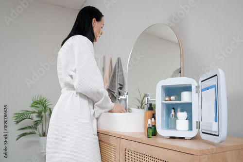 Young woman washing hands n...