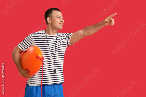 Happy male lifeguard with l...