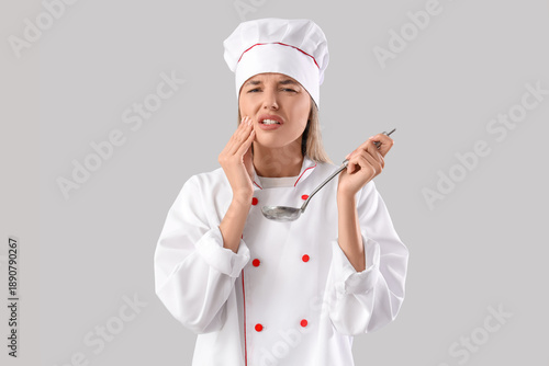 Young female chef with ladl...