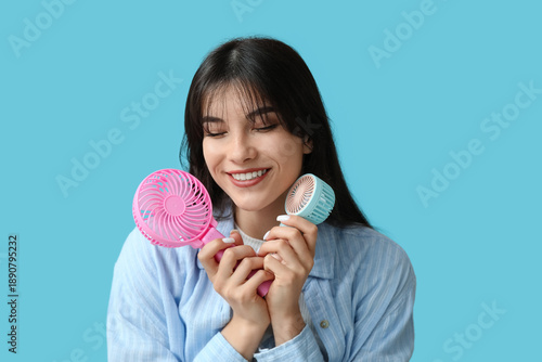 Young woman with mini fans ...