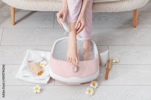 Woman with massage foot bat...