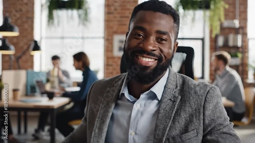 Wallpaper Mural Happy businessman with beard in office, looking at camera Torontodigital.ca