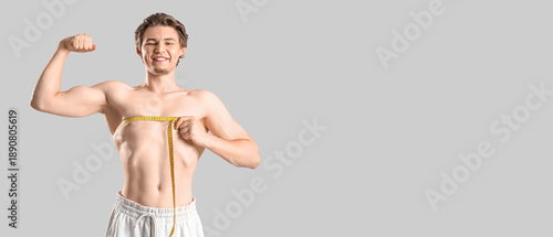 Young man measuring his che...
