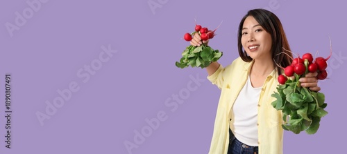 Happy young Asian woman holding ripe radish on lilac background with space for text