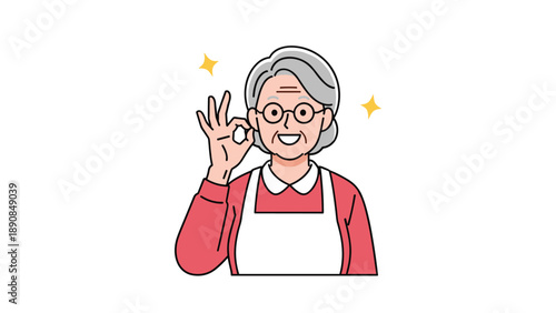 Smiling senior woman with grey hair in red sweater and white apron making okay sign with her hand in satisfaction.