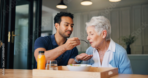 Nurse, man and feeding breakfast with old woman for assisted living, support or nutrition at house. People, caregiver and helping hand with elderly patient, meal and food for diet at nursing home