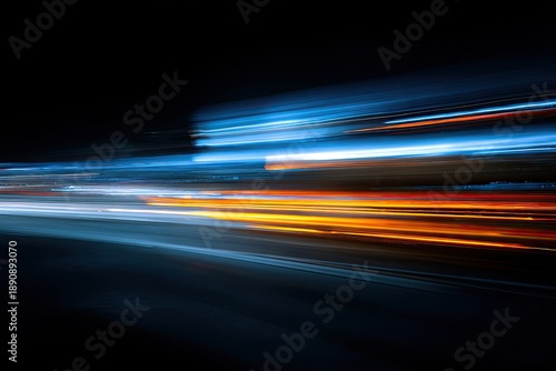 Abstract streaks of vibrant blue and orange light blur across a dark background