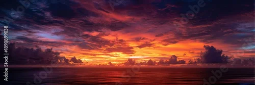 Obraz  z motywem Dramatic sunset over the ocean with fiery clouds and shimmering water