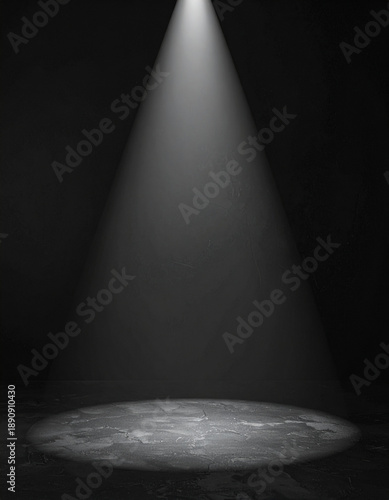 A black background with a single prominent spotlight illuminating it