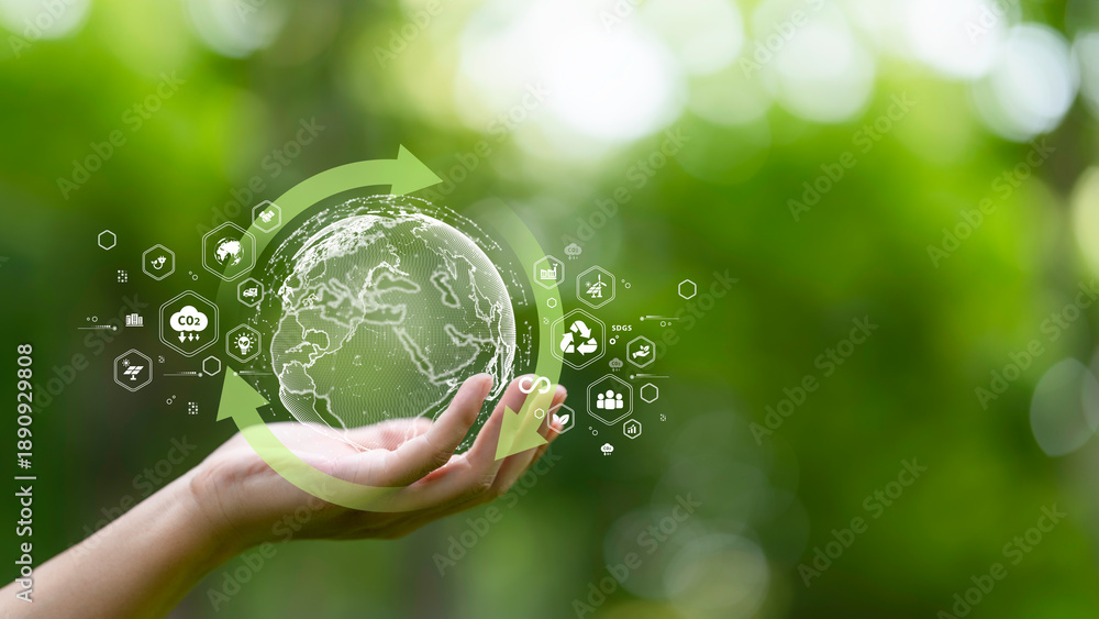 Obraz premium hand holding digital earth with circular economy concept. renewable energy, resource efficiency, waste reduction, ESG strategy, SDGs, and sustainable environment green business innovation.