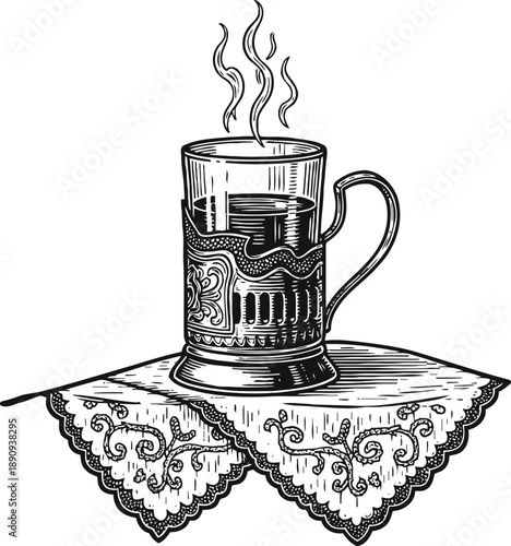 Hot tea in a decorative glass holder on embroidered lace napkin with steam rising
