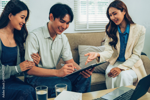 Couple Signing Contract or Agreement with Female Financial Advisor
