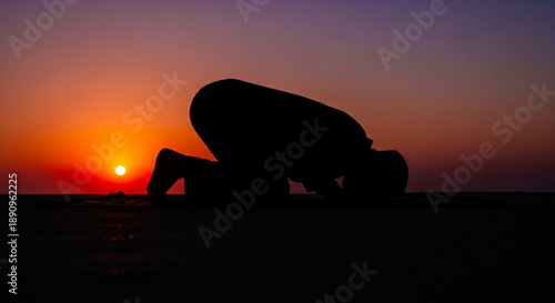Person in yoga pose at serene sunset with orange purple sky and peaceful atmosphere outdoors