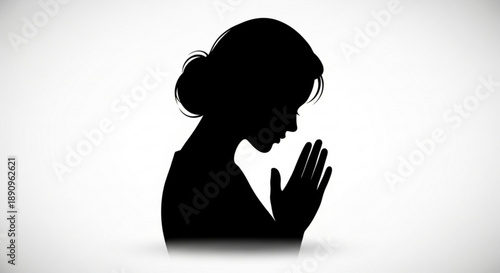 Silhouette of a woman praying with hands clasped in contemplation on white background