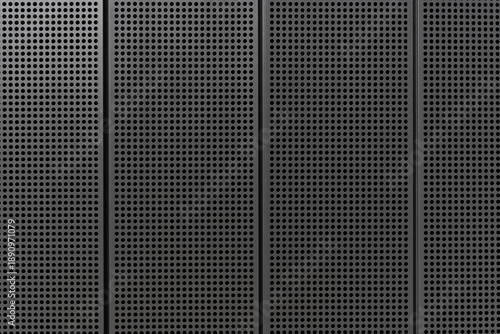 Dark perforated metal wall texture with geometric industrial pattern