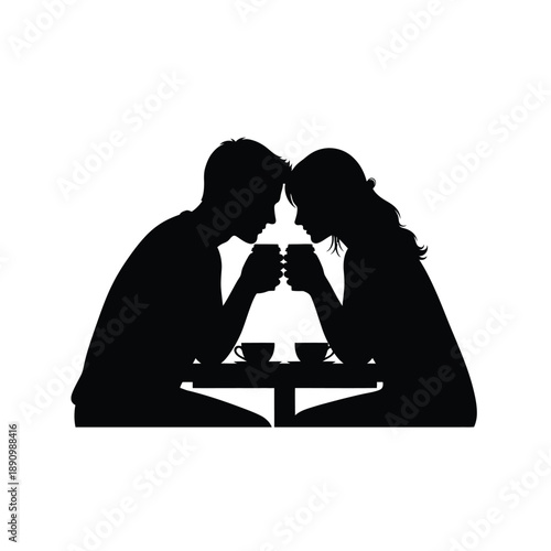 Silhouette of a romantic couple sitting at a cafe table and drinking coffee